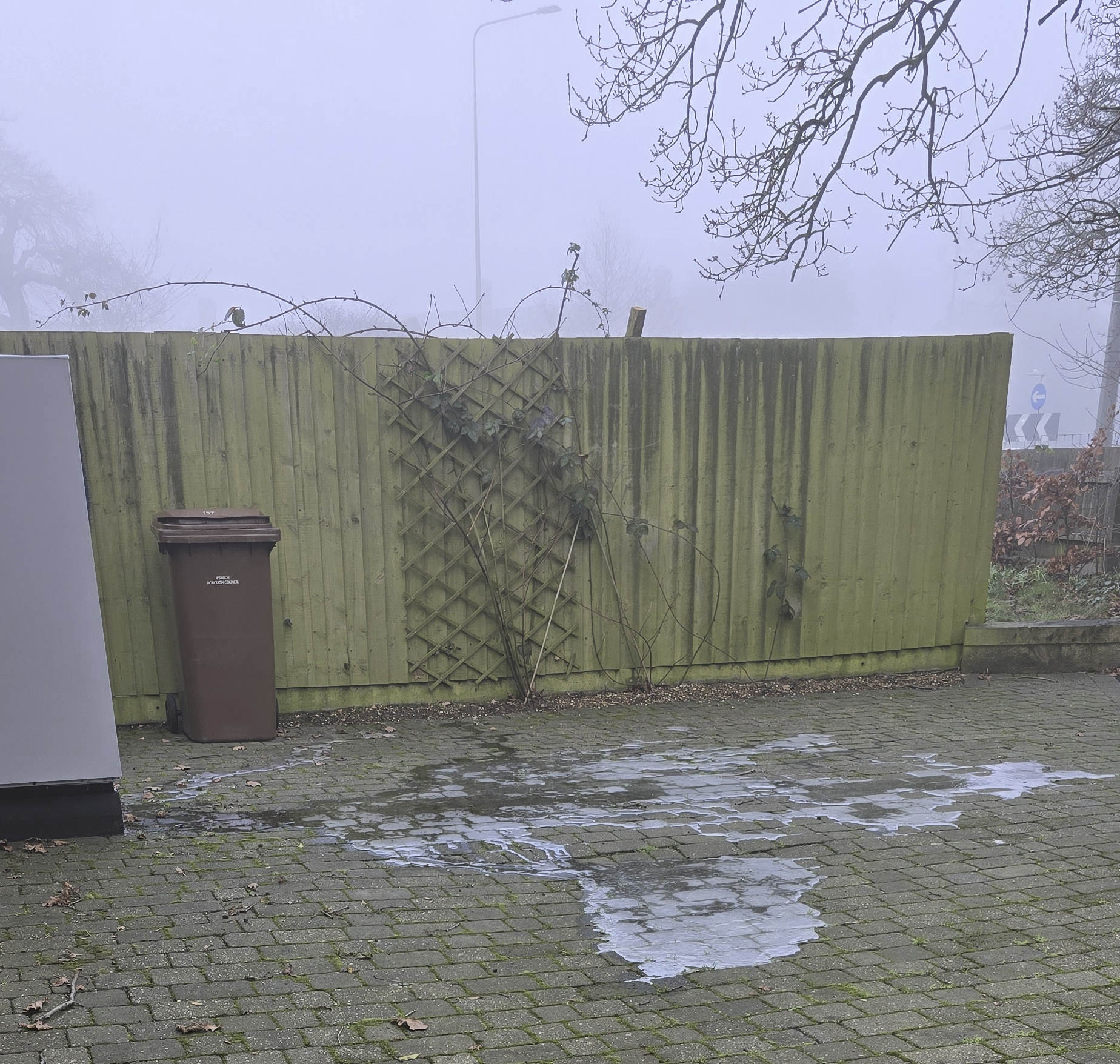 A patch of Ice formed from the Heat Exchanger, pictured, seen to the left of the patch of ice on the driveway.